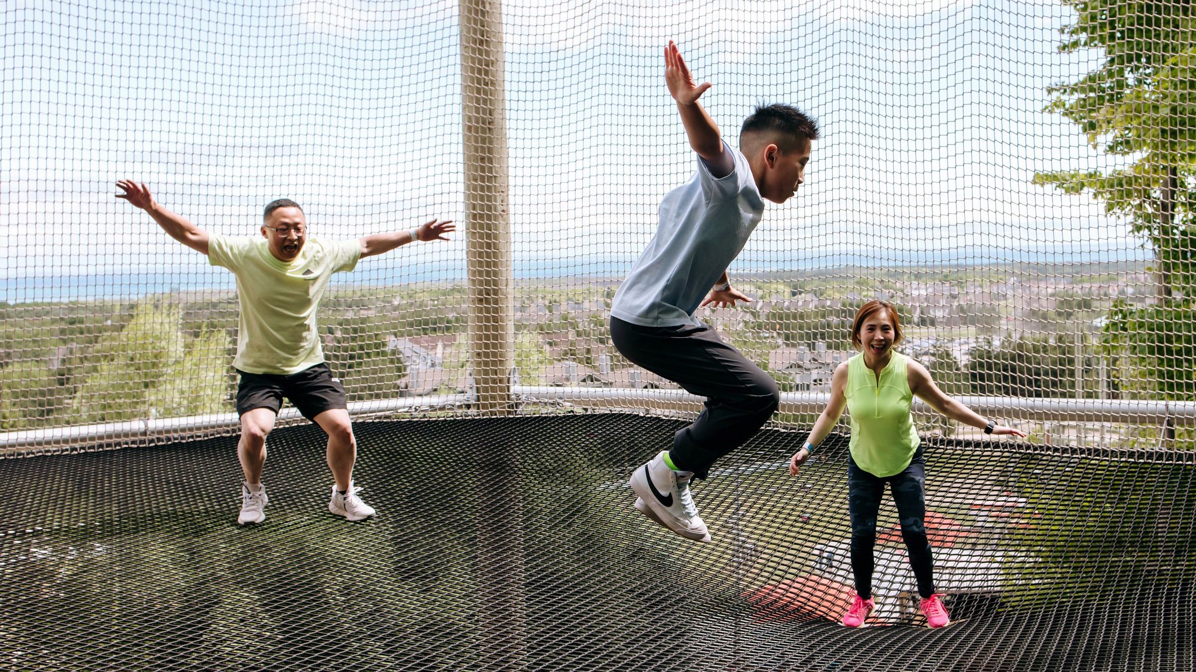 Family jumping on Canopy Climb trampoline in Adventure Park at Blue Mountain