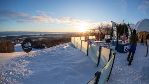 A group of skiers on a snow covered slope.