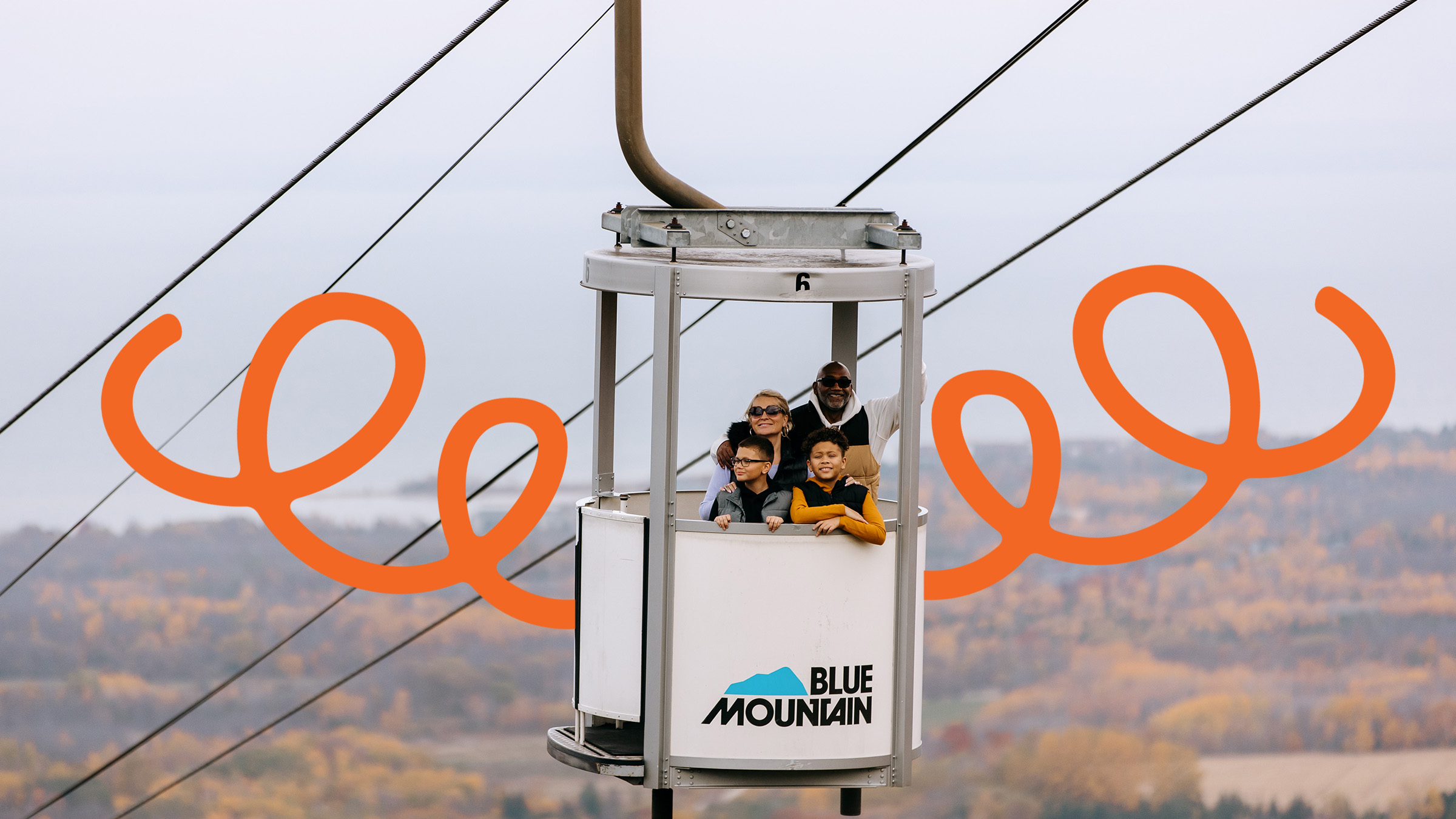 Family riding the gondola up the mountain at Blue Mountain