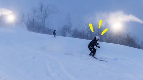 5x7® Pass holder riding down the run while the snowmaking guns are turned on at Blue Mountain Resort