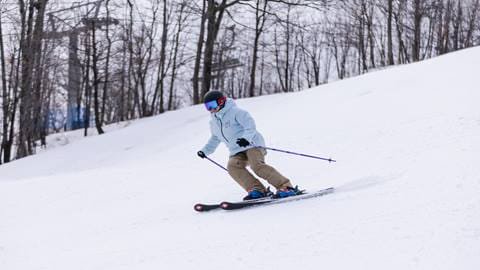 Person skiing down run at Blue Mountain