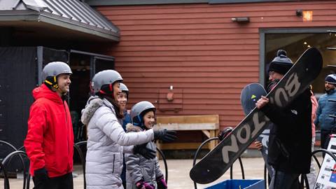 A family picking up their ski and snowboard equipment rentals at Blue Mountain Resort