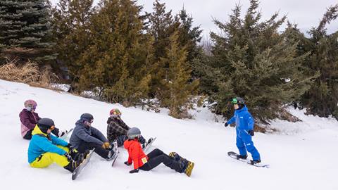 Group of new snowboarders learning to snowboard at Blue Mountain Resort