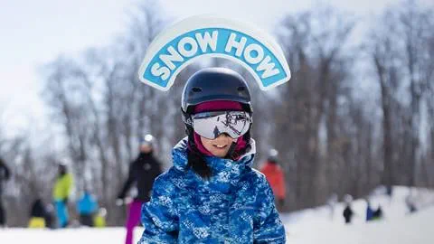 Kid learning how to ski and learning how to snowboard at Blue Mountain with Snow How Kids