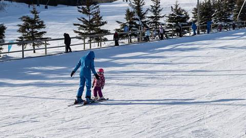Instructor with child on beginner hill at Blue Mountain