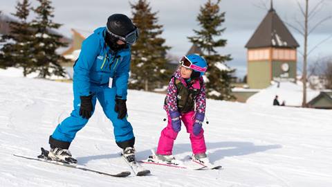 Toddler learning to ski during Tiny Tot Private ski lesson at Blue Mountain