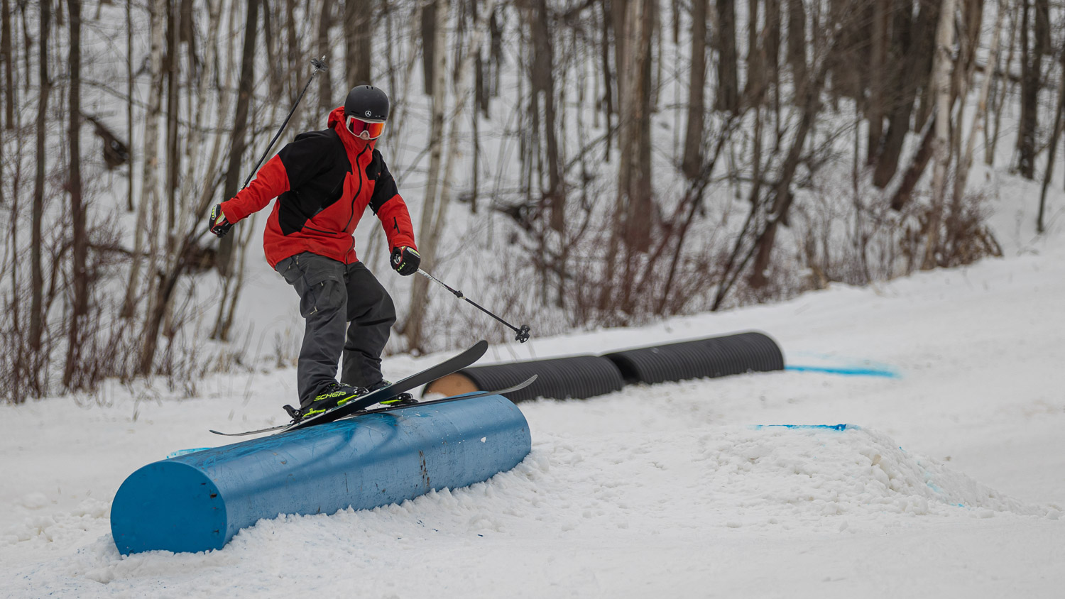 Skier going down rail while Learning to ski in the park at Blue Mountain