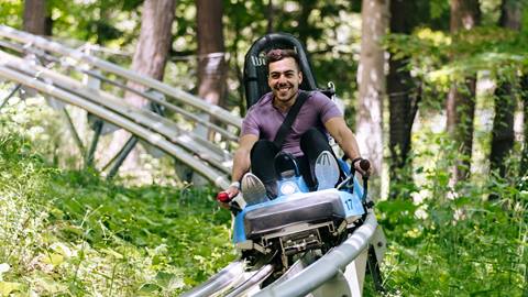 A man riding the Ridge Runner Mountain Coaster at Blue Mountain Resort