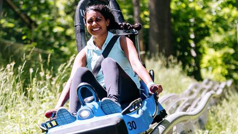 A lady riding the Ridge Runner Mountain Coaster at Blue Mountain Resort