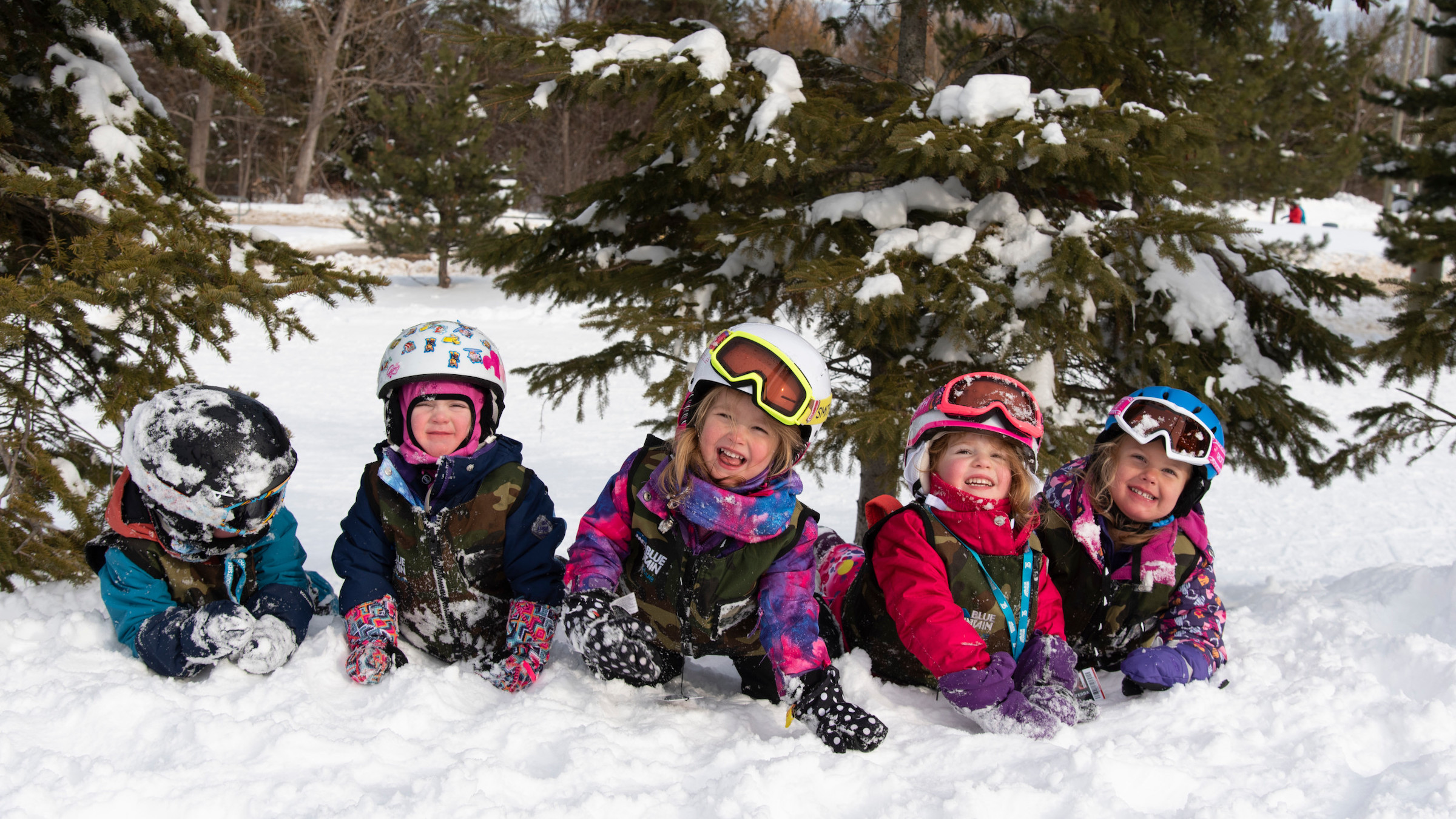Kids laying on Beginner hill at Blue Mountain during Kids Program