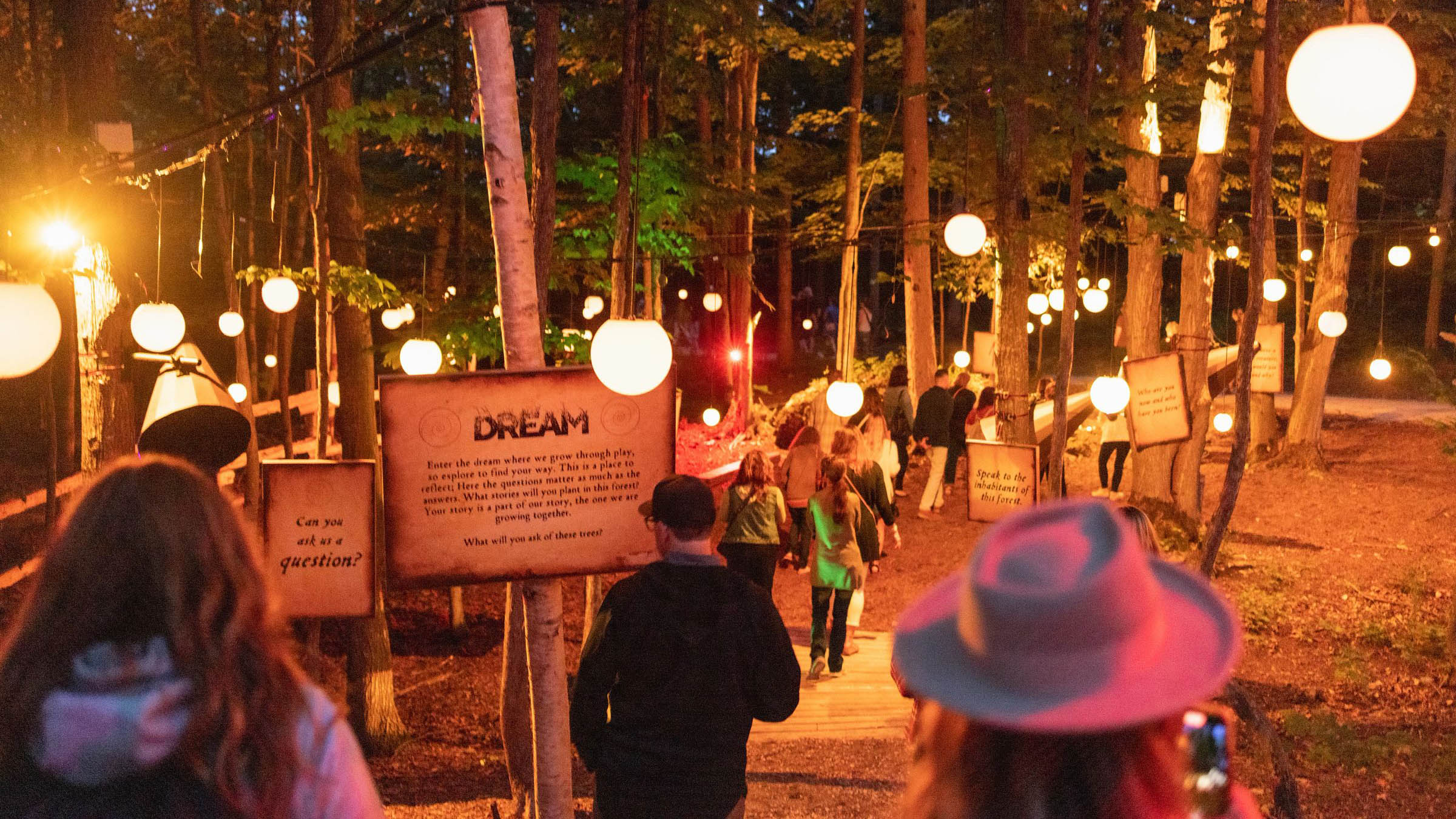 Group of people walking through the AGORA Path of Light at Blue Mountain Resort