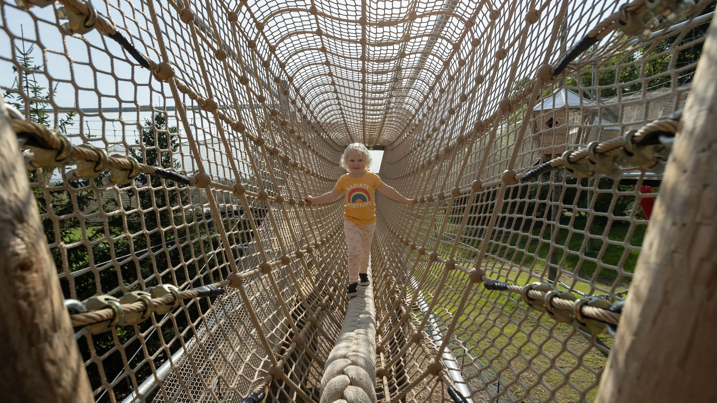 Child wandering through the canopy climb net adventure course at Blue Mountain