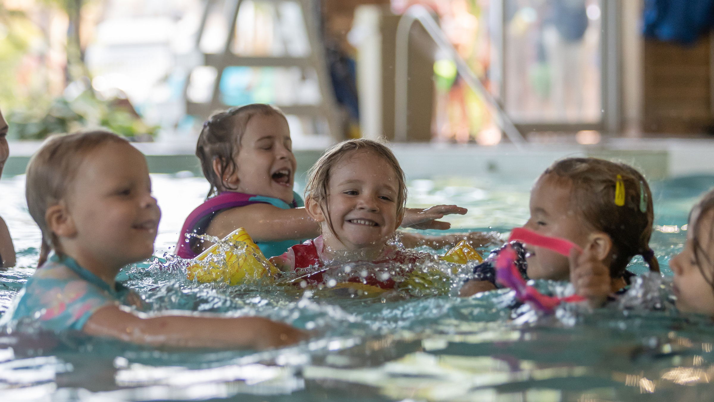 Kids laughing and swimming in pool at plunge aquatic centre Blue Mountain