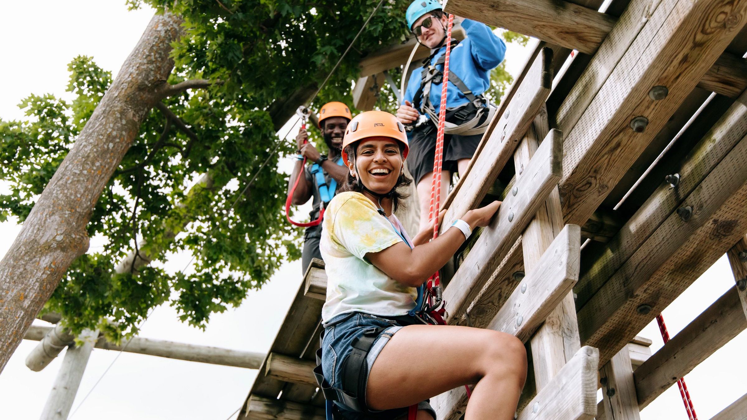 Friends climbing through course on Timber Challenge at Blue Mountain