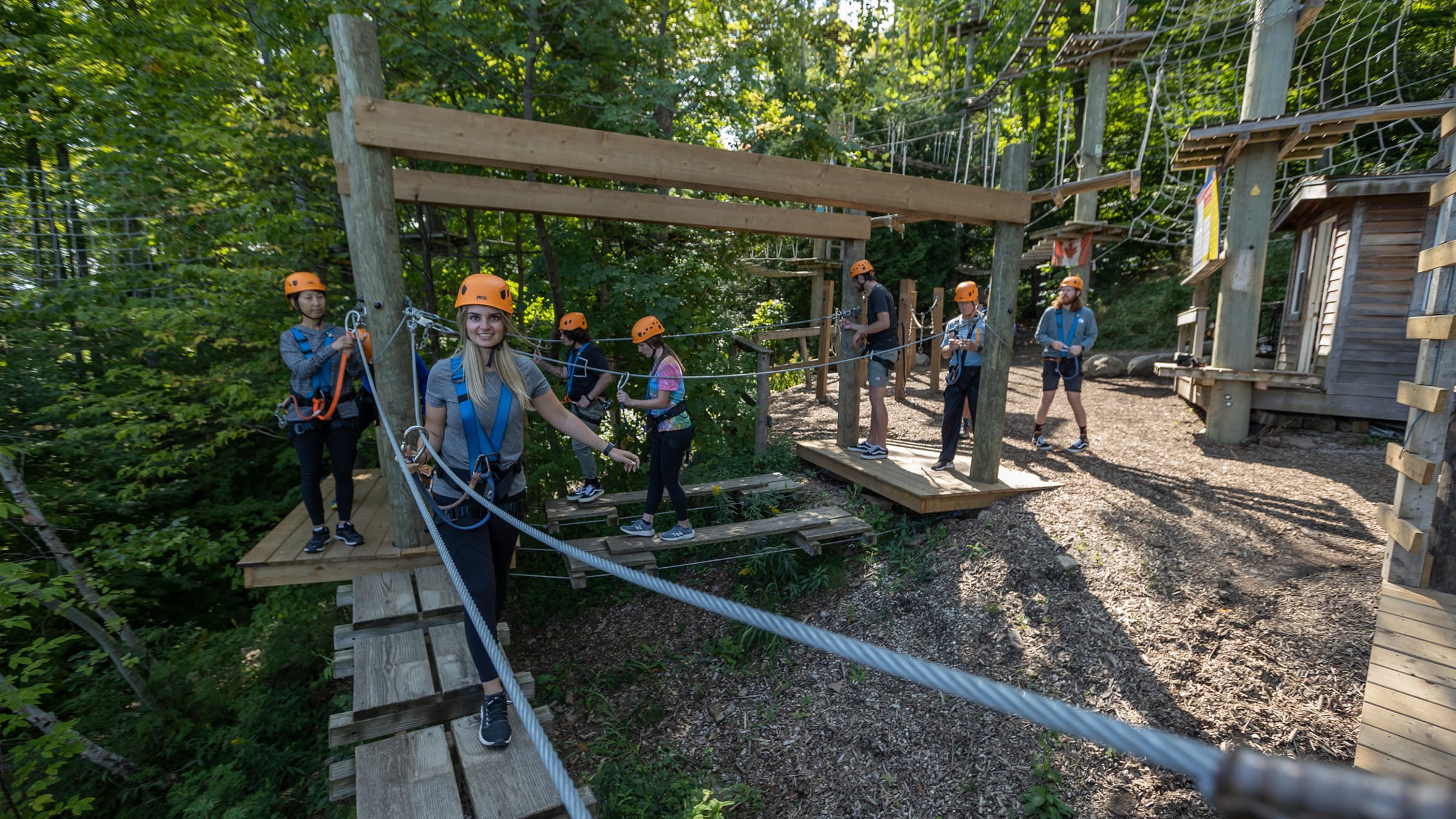 Group of people learning to use the ropes course at Timber Challenge High Ropes Course at Blue Mountain Resort
