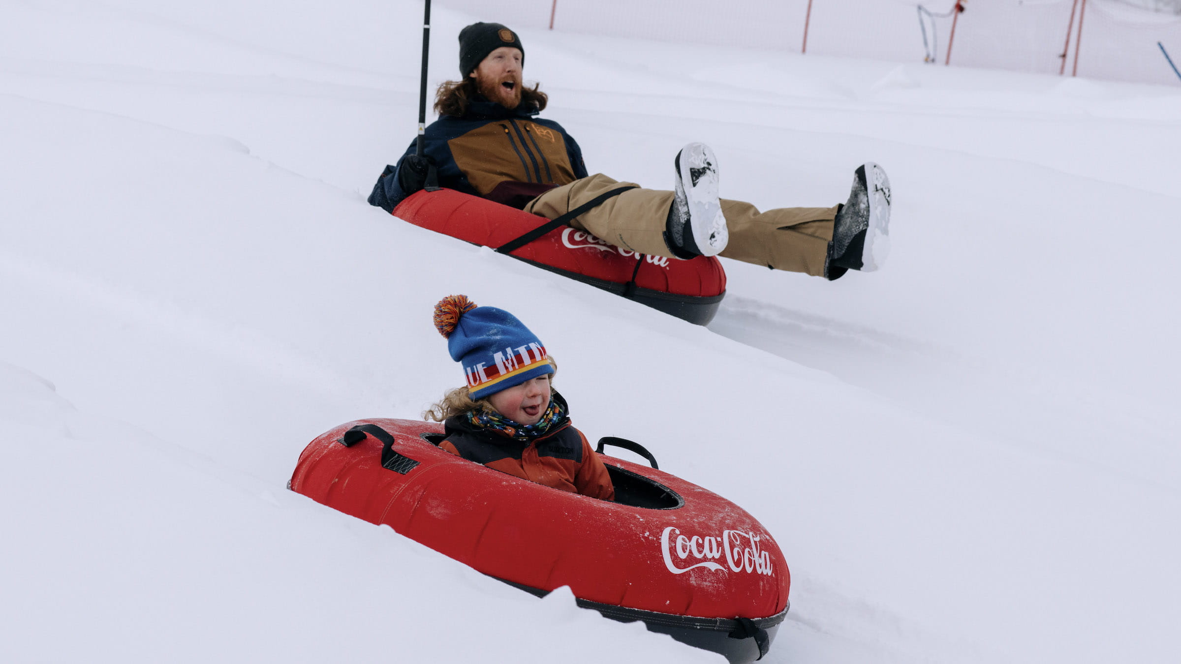 Two people in tubes going down Blue Mountain Tubing Winter Attraction at Blue Mountain