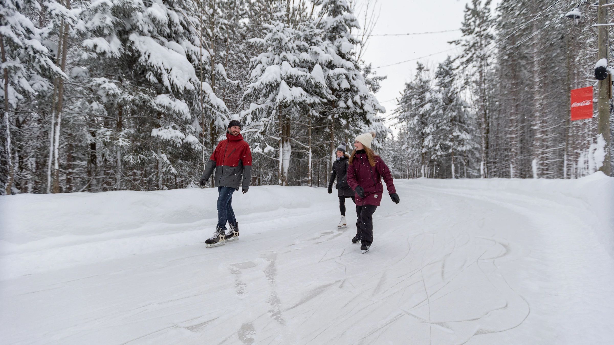 Three friends skating in the trees at the top of Blue Mountain at Woodview Skating 