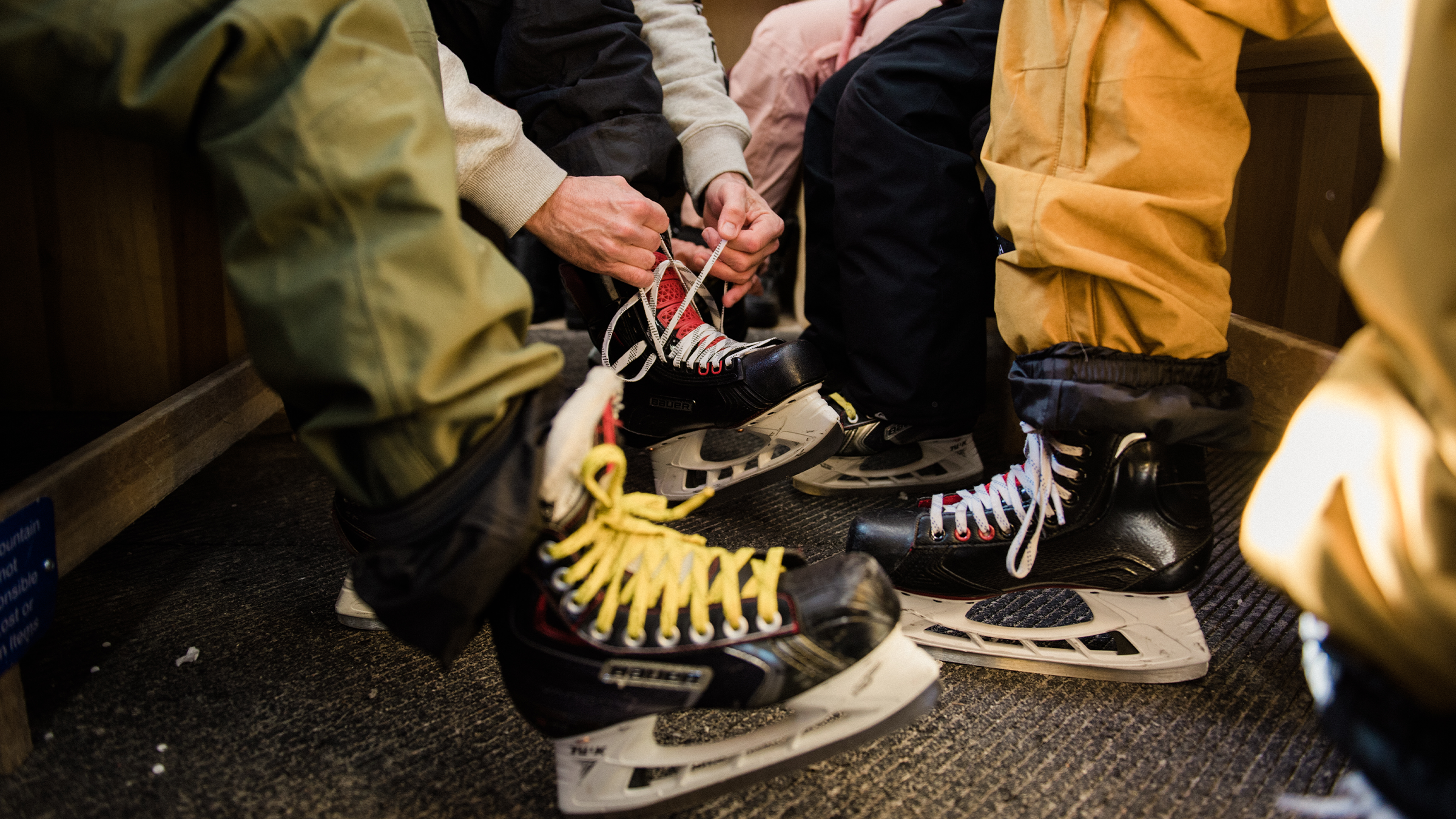 People tying up their skate rentals to go skating at Blue mountain