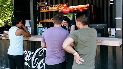 Group of people ordering food at the Coca-Cola Concession stand