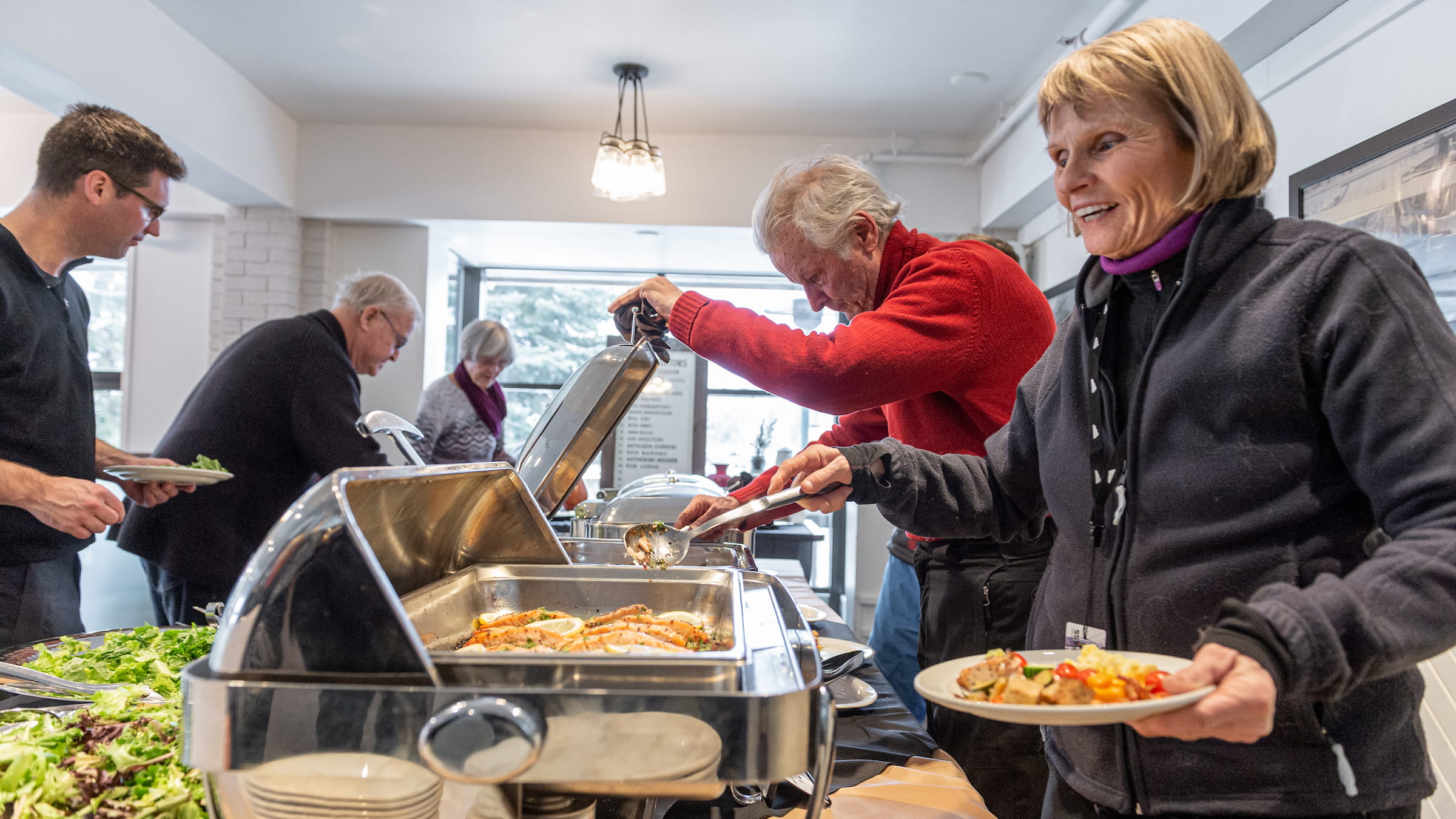 People serving food at the breakfast buffet at the Pottery Breakfast Buffet at Blue Mountain