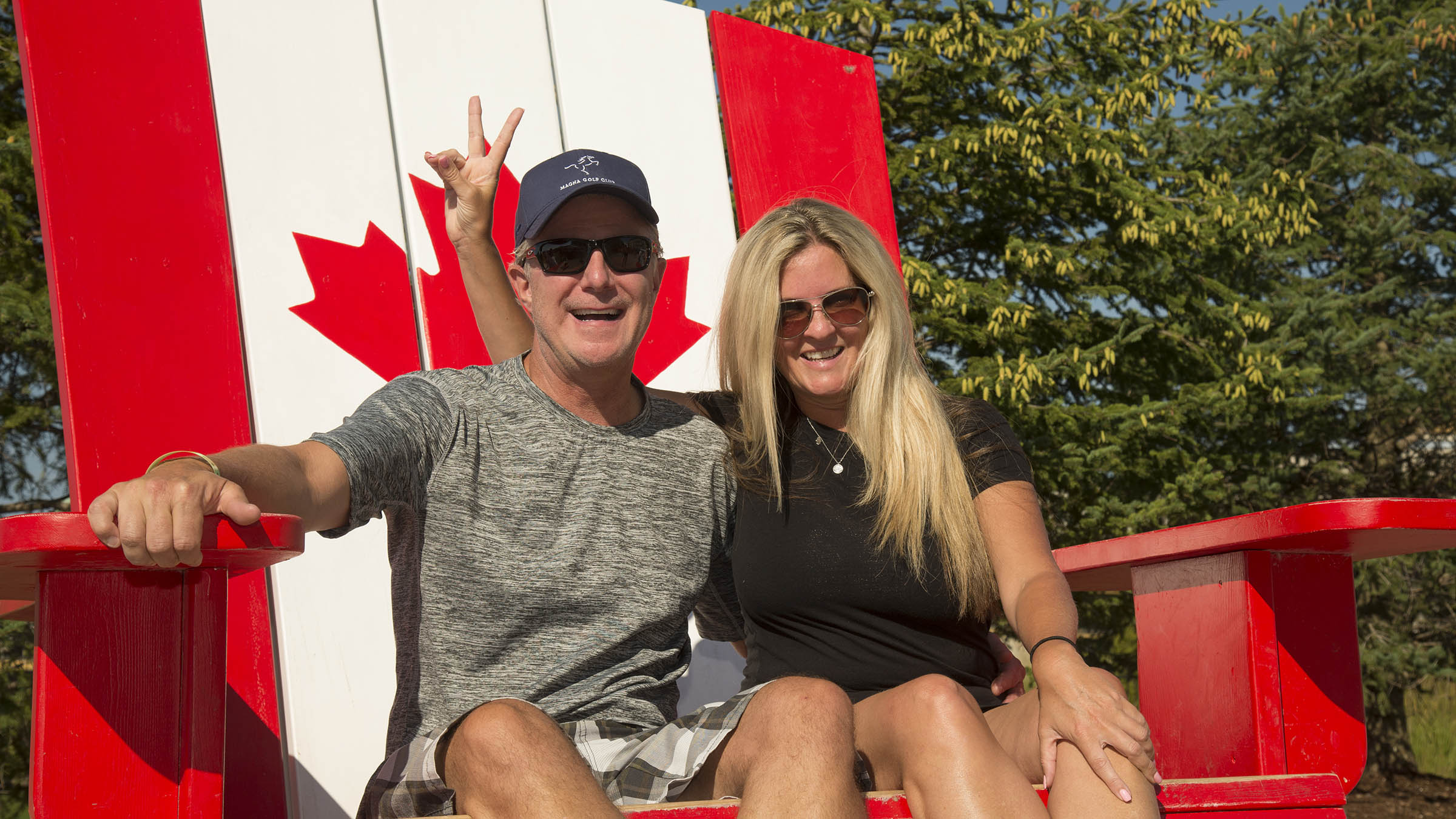 Couple sitting in giant Muskoka chair at Blue Mountain