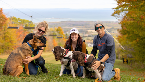 A man and two women with their dogs at Blue Mountain Resort