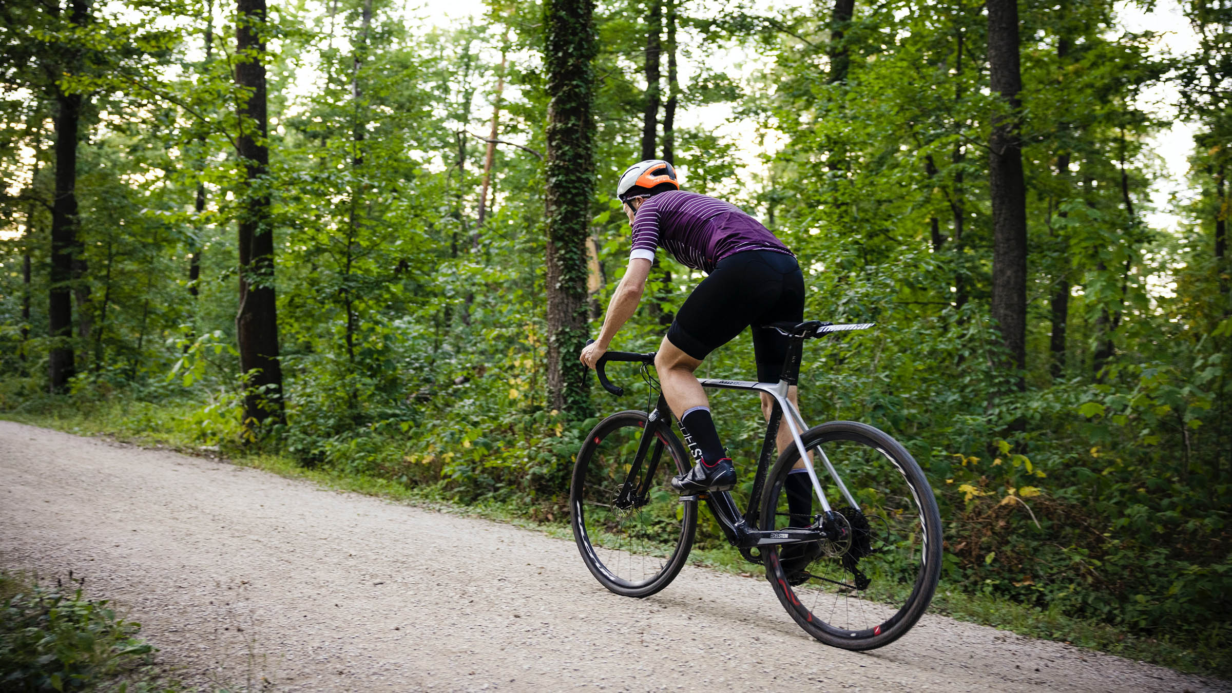 Person biking along gravel road