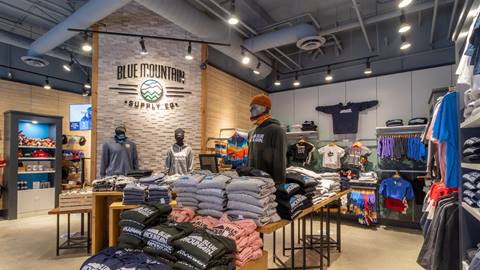 Shopping at Blue Mountain Supply Co. inside store with clothing