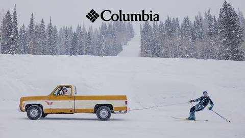 Columbia skis a truck in the snow.