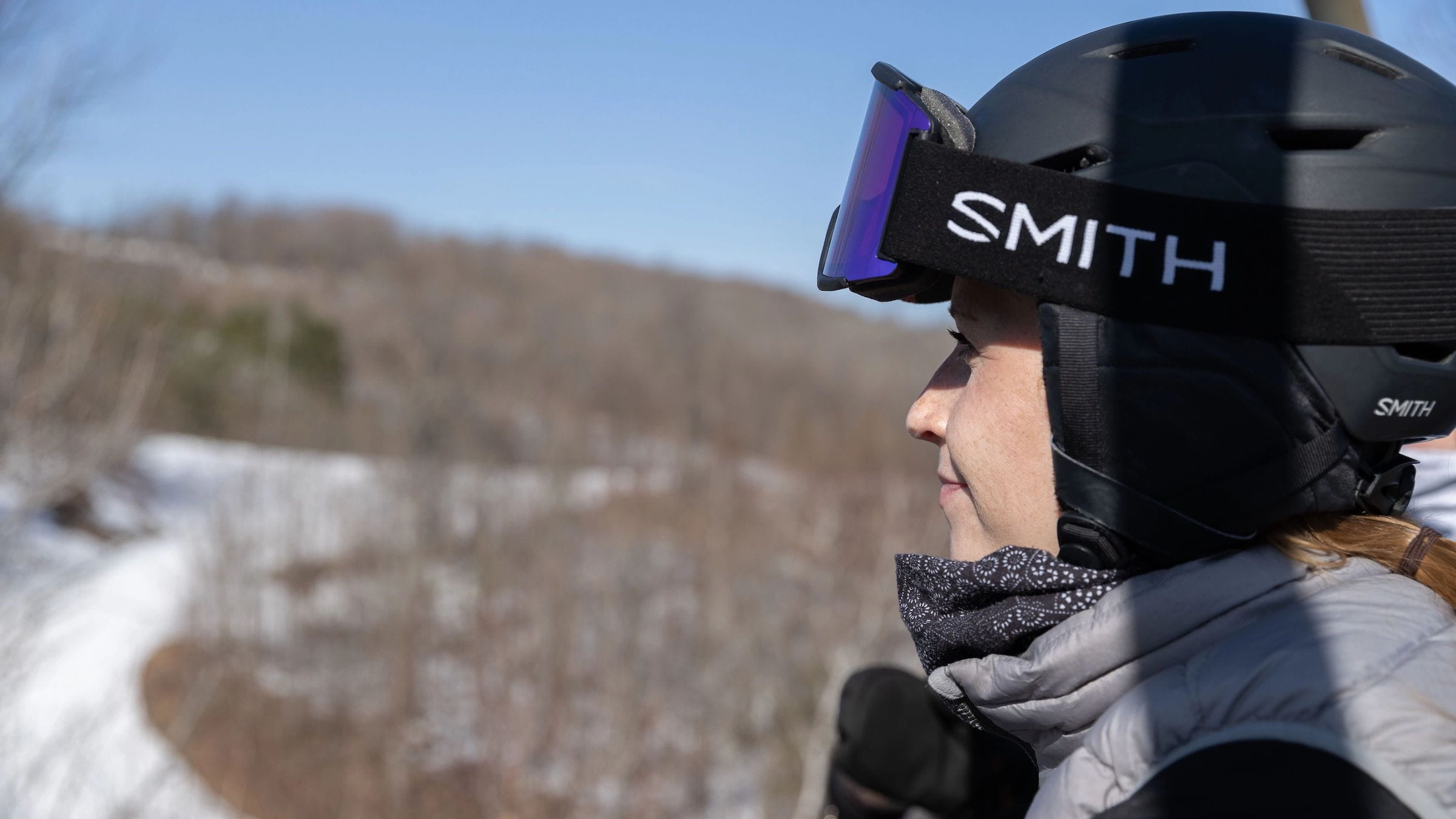 Woman with Smith Goggles looking out at Blue Mountain
