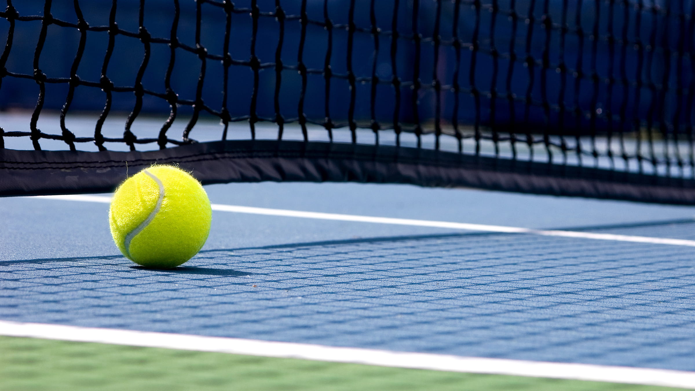 Tennis ball sitting on court during Tennis camp for kids at Blue Mountain