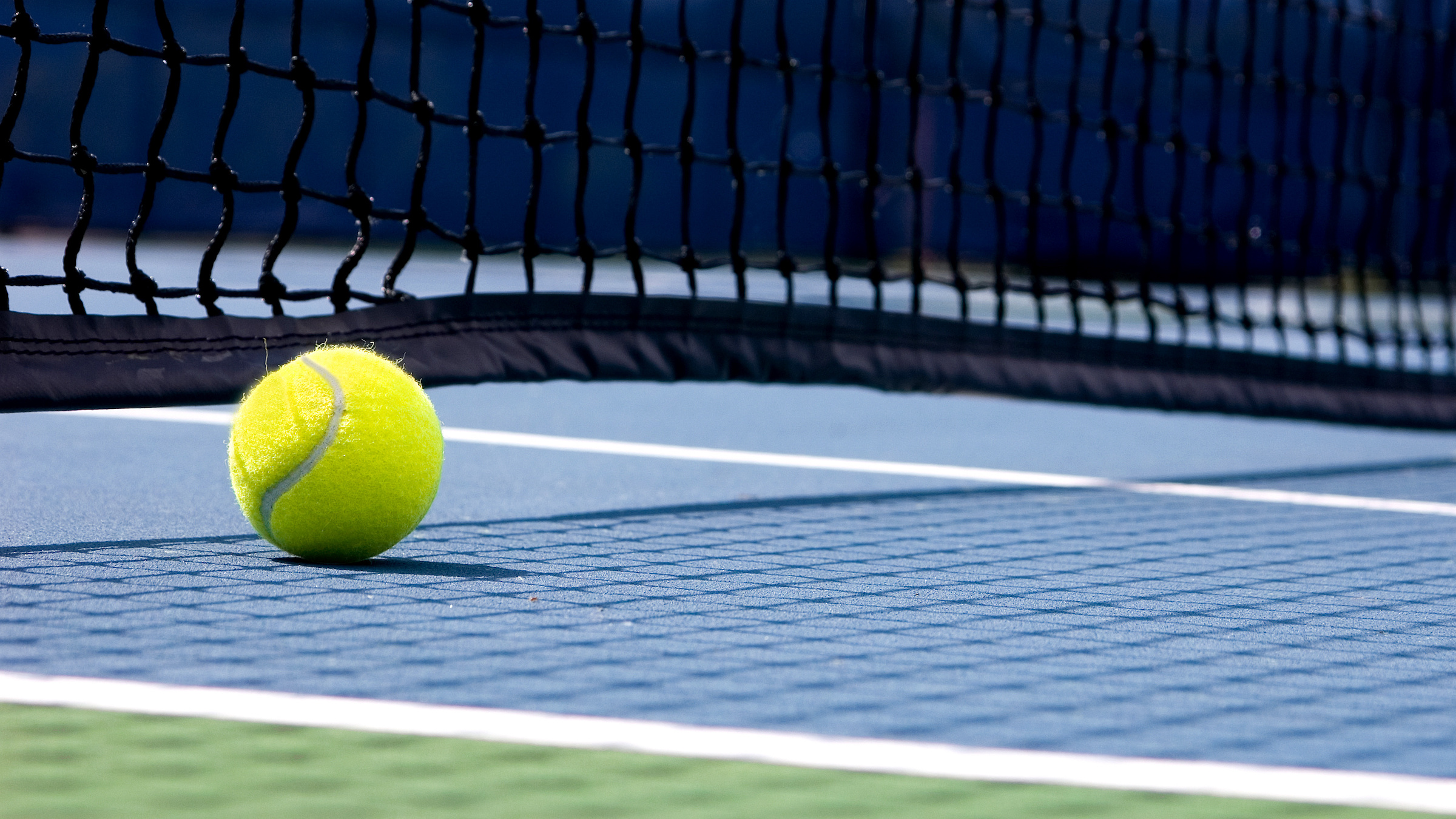 Tennis ball sitting on court during Tennis camp for kids at Blue Mountain