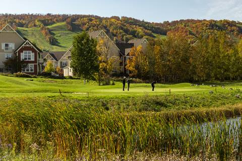 A group of people on a golf course.