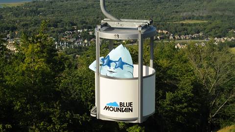 the yeti from YetiCon riding the Open-Air Gondola