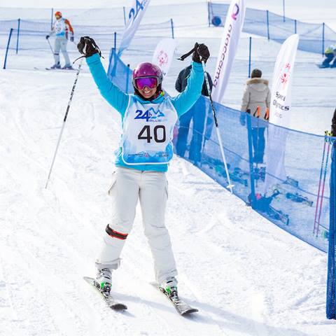 a skier with their hands in the air