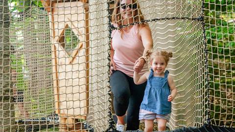 Woman and young girl walking on net