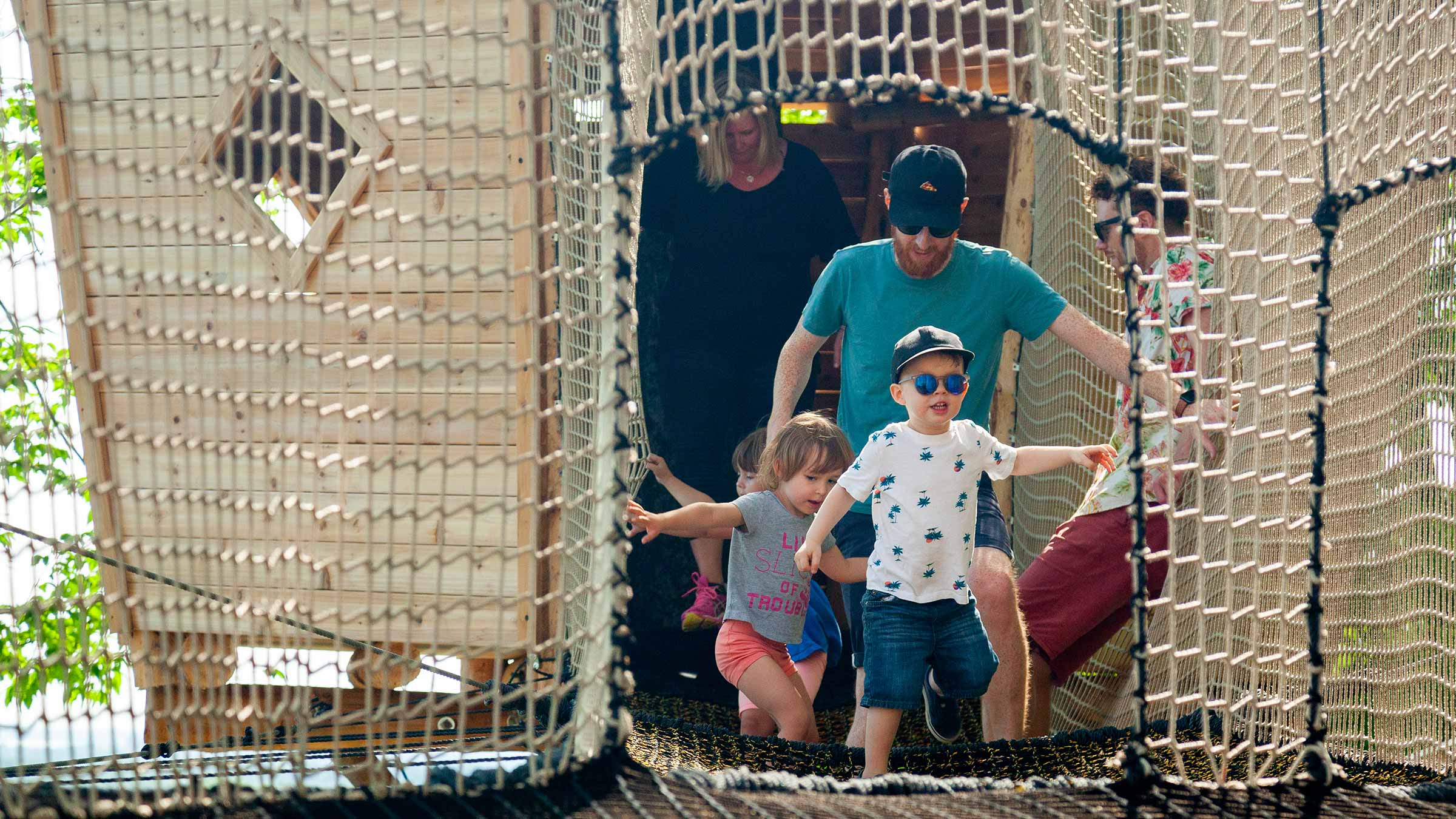 Kids and Adults coming out of tree house on Canopy Climb