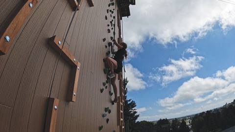 climbing using legs to climb up wall