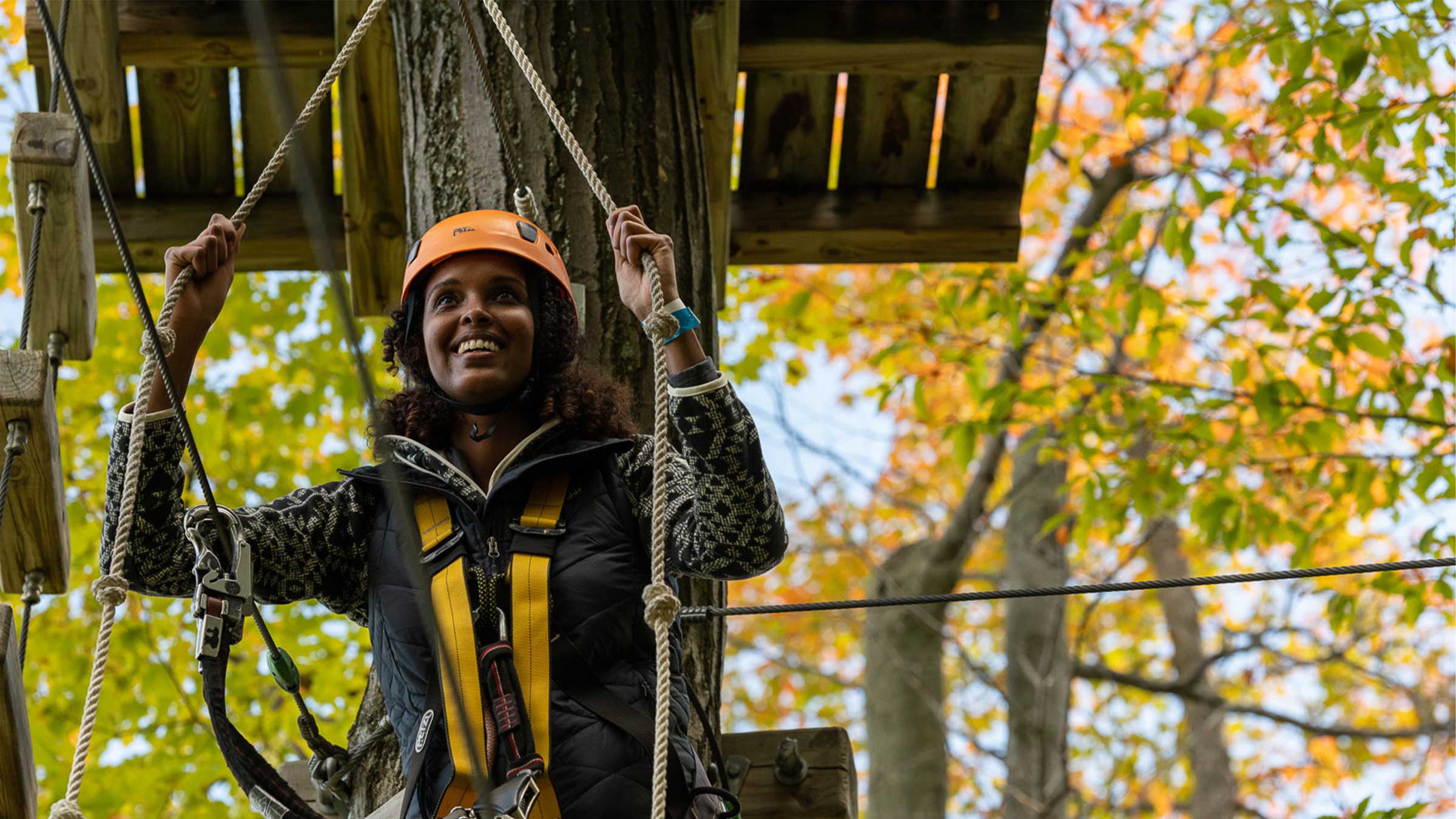 women on ropes course in autumn