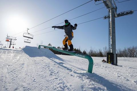 Snowboarder On Rail Terrain Park
