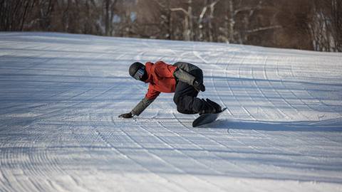 a man riding skis down a snow covered slope