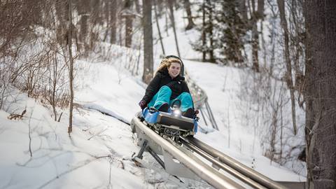 a person riding the ridge runner mountain coaster on the snow