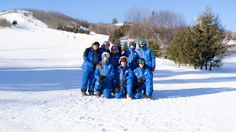 a group of people posing for a picture in the snow