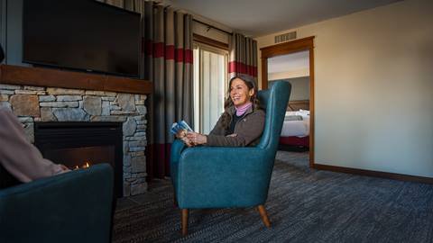 a person sitting on a chair in a living room