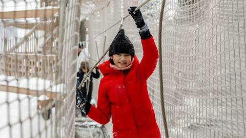 a person standing in front of a fence