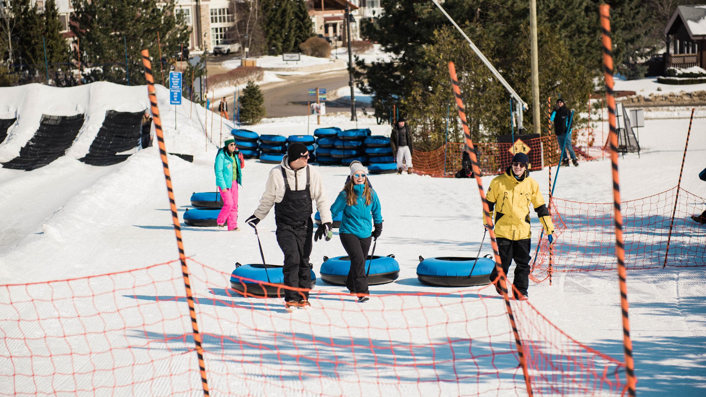 Group of young adults snow tubing