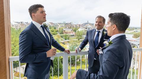 Groom and groomsmen on balcony in Blue Mountain hotel