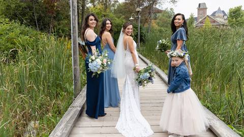 Bride and bridesmaids walking along path at Blue Mountain Resort