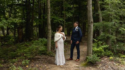 Bride and Groom walking through forest at Blue Mountain Resort