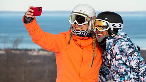 Winter lifestyle - individuals, couples and families interacting in ski and snowboard gear